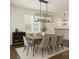 Dining room with large dining table, stylish modern lighting, and neutral color palette at 1962 Bainbridge Ln, Atlanta, GA 30345