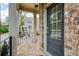 View from the porch looking through a glass storm door of a brick townhome at 1962 Bainbridge Ln, Atlanta, GA 30345