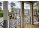 View of townhomes from the covered porch with decorative railing and hardscaped walkway at 1962 Bainbridge Ln, Atlanta, GA 30345
