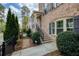 Brick townhome with landscaped front yard, black railings, and covered entryway at 1962 Bainbridge Ln, Atlanta, GA 30345