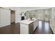 Stylish kitchen island with white cabinetry, stainless steel dishwasher, and connection to an open living area at 1962 Bainbridge Ln, Atlanta, GA 30345