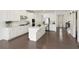 Open kitchen boasts white cabinetry, stainless appliances, dark floors, and seamless flow to the living area at 1962 Bainbridge Ln, Atlanta, GA 30345