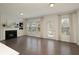 Bright living room with fireplace, built-in shelving, large windows, and dark wood floors at 1962 Bainbridge Ln, Atlanta, GA 30345