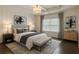 Bedroom with shiplap accent wall, tray ceiling, and a cozy bench at the foot of the bed at 1962 Bainbridge Ln, Atlanta, GA 30345