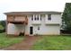 The home has a two-story back elevation with a deck overlooking the backyard at 301 Thorn Thicket Dr, Rockmart, GA 30153