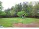 Large grassy backyard is ideal for outdoor play with a play set at 301 Thorn Thicket Dr, Rockmart, GA 30153