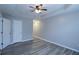 Spacious bedroom with gray flooring, a tray ceiling, a ceiling fan, and access to a closet and bathroom at 301 Thorn Thicket Dr, Rockmart, GA 30153
