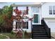 Charming two-story home with a green front door and stairs leading to the front entrance at 301 Thorn Thicket Dr, Rockmart, GA 30153