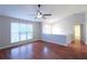 Bright, open-concept living room with hardwood floors, ceiling fan and a view of the upstairs hallway at 301 Thorn Thicket Dr, Rockmart, GA 30153