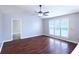 Bright living room featuring hardwood floors, a ceiling fan, and natural light from a large window at 301 Thorn Thicket Dr, Rockmart, GA 30153