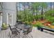 Outdoor dining on deck featuring a grill and wooded backyard view at 135 High Point Walk, Atlanta, GA 30342