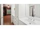 Bright bathroom with white vanity, double sinks, and built-in storage at 135 High Point Walk, Atlanta, GA 30342