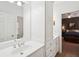 Bright bathroom featuring white cabinets, granite counters, and a door leading into an adjoining bedroom at 135 High Point Walk, Atlanta, GA 30342