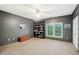 Bedroom featuring neutral carpet, built in shelving, and a window with a peaceful backyard view at 135 High Point Walk, Atlanta, GA 30342