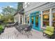 Outdoor deck features dining furniture and charming blue doors, perfect for entertaining at 135 High Point Walk, Atlanta, GA 30342