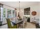 Elegant dining room with modern lighting, a built in bar, and seating for six at 135 High Point Walk, Atlanta, GA 30342