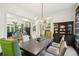 Stylish dining room featuring a dark wood table, designer lighting, and an open view to the living room at 135 High Point Walk, Atlanta, GA 30342