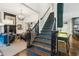 Open entryway with fireplace, living room, stairs to the second floor, and view of kitchen at 135 High Point Walk, Atlanta, GA 30342