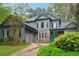 Two-story home featuring stone accents, a gray exterior, and a well-manicured front yard at 135 High Point Walk, Atlanta, GA 30342