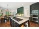 Open kitchen with an island cooktop and stainless appliances, seamlessly connected to the dining and living areas at 135 High Point Walk, Atlanta, GA 30342