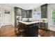 Modern kitchen features a center island with seating, stainless steel appliances, and ample cabinet space at 135 High Point Walk, Atlanta, GA 30342