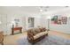 Bright living room with a ceiling fan, white trim, large area rug, and comfortable furnishings at 135 High Point Walk, Atlanta, GA 30342