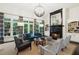Bright living room with fireplace, large windows, stylish furniture, and built in bookshelves at 135 High Point Walk, Atlanta, GA 30342