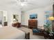 Bright main bedroom with sitting area, ceiling fan, desk, television, and access to the backyard at 135 High Point Walk, Atlanta, GA 30342