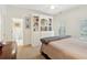 Main bedroom features neutral carpet, bright white trim, built in shelving, and attached bathroom at 135 High Point Walk, Atlanta, GA 30342