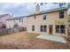 A view of the home's backyard with a small concrete patio and an old wooden fence at 1498 Scenic Pines Dr, Lawrenceville, GA 30044