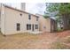 An outdoor shot of the home's backyard featuring a small patio and a view of the home's siding at 1498 Scenic Pines Dr, Lawrenceville, GA 30044