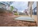 A backyard with a concrete slab and sloped hill at 1498 Scenic Pines Dr, Lawrenceville, GA 30044