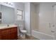 Bathroom featuring a sink, toilet, and tub with shower head at 1498 Scenic Pines Dr, Lawrenceville, GA 30044