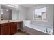 Bathroom featuring a soaking tub and vanity with modern finishes at 1498 Scenic Pines Dr, Lawrenceville, GA 30044