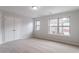 Bedroom featuring neutral carpet and windows at 1498 Scenic Pines Dr, Lawrenceville, GA 30044