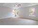 Large bedroom with tray ceiling and neutral carpet at 1498 Scenic Pines Dr, Lawrenceville, GA 30044