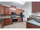 Kitchen with stainless steel appliances, dark countertops, and wood cabinets at 1498 Scenic Pines Dr, Lawrenceville, GA 30044