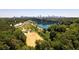 Scenic aerial view showcasing lake, forest, and city skyline in the distance at 1741 Liberty Nw Pkwy, Atlanta, GA 30318