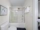 Cozy bathroom featuring a white tub-shower with glass doors, white towel, and gray walls at 1741 Liberty Nw Pkwy, Atlanta, GA 30318