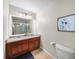 Bright bathroom featuring a double sink vanity with cherry wood cabinets and framed mirror at 1741 Liberty Nw Pkwy, Atlanta, GA 30318