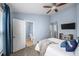 This airy bedroom with blue walls offers a great view of the ensuite bathroom and features a ceiling fan at 1741 Liberty Nw Pkwy, Atlanta, GA 30318