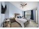 This bedroom boasts a ceiling fan, comfortable carpet, and TV for restful nights and enjoyable mornings at 1741 Liberty Nw Pkwy, Atlanta, GA 30318