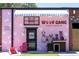 Whimsical pink storefront of Woof Gang Bakery & Grooming, decorated with playful illustrations and details at 1741 Liberty Nw Pkwy, Atlanta, GA 30318