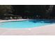 Community pool surrounded by lounge chairs and lush landscaping; perfect for relaxation and recreation at 1741 Liberty Nw Pkwy, Atlanta, GA 30318