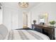 Comfortable bedroom with neutral decor, a modern ceiling light, and a view into the hallway at 2200 Cortland Rd, Milton, GA 30009