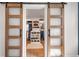 Walk-in closet with custom shelving and sliding barn doors for easy access at 2200 Cortland Rd, Milton, GA 30009
