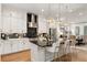 Bright kitchen with white cabinets, stainless steel appliances, and large island with seating at 2200 Cortland Rd, Milton, GA 30009