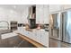 Gourmet kitchen with modern appliances, black backsplash, and white cabinets with gold hardware at 2200 Cortland Rd, Milton, GA 30009