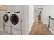 Conveniently located laundry area with modern washer and dryer units and hardwood flooring at 2200 Cortland Rd, Milton, GA 30009