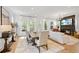 Open-concept living room with fireplace, hardwood floors, and ample natural light at 2200 Cortland Rd, Milton, GA 30009
